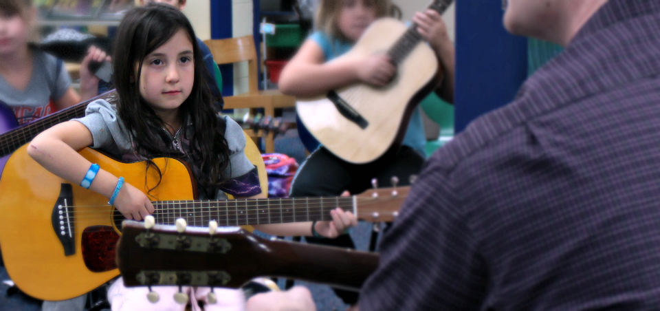 Little girl playing guitar