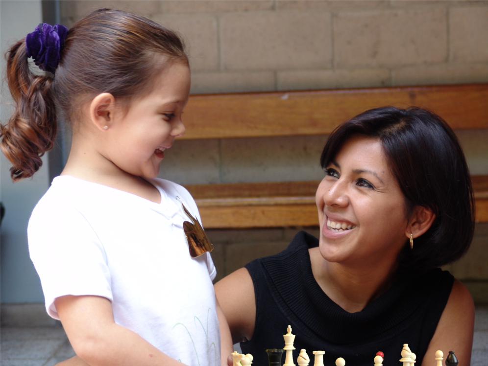 Instructor giving prize to little kid